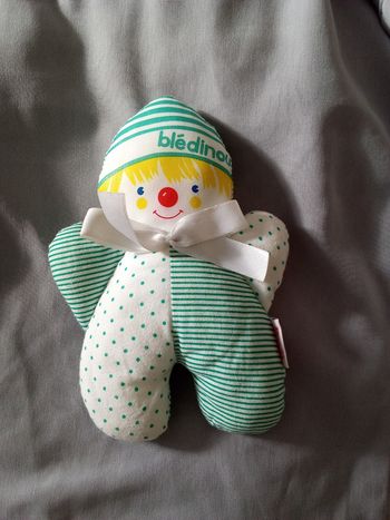 doudou clown  de la marque Corolle de 1994 en tissu 18 cm de haut noeud satin blanc au cou