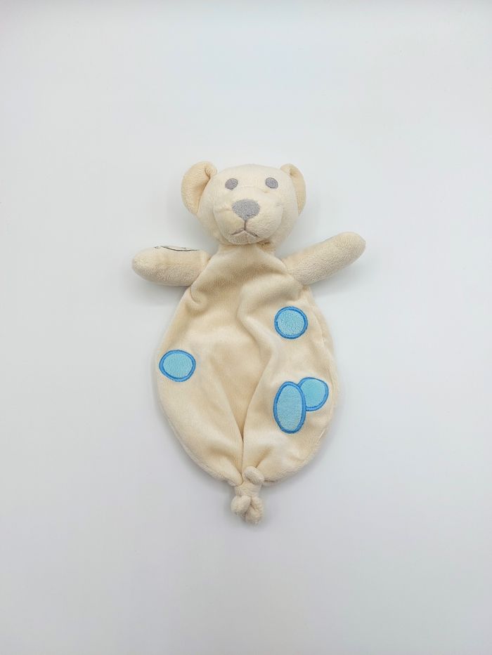 Doudou plat ours écru crème DECAROLI COSFIBEL rond bleu yeux gris