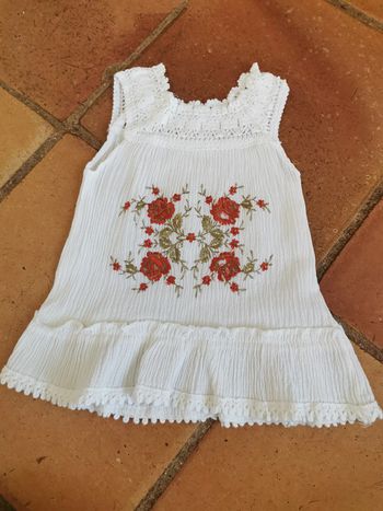 Robe blanche brodée de fleurs rouges