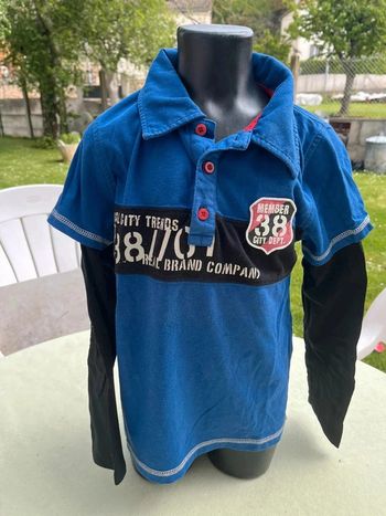 Polo bleu avec manche longue cousu noir taille 8 ans
