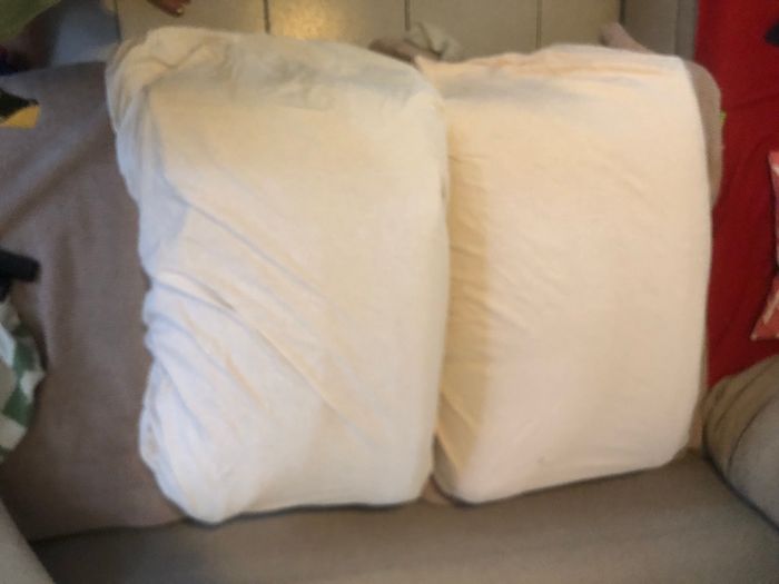 2 draps housses blancs pour matelas de bébé.