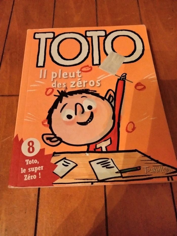 Livre intitulé Toto il pleut des zéros tourbillon