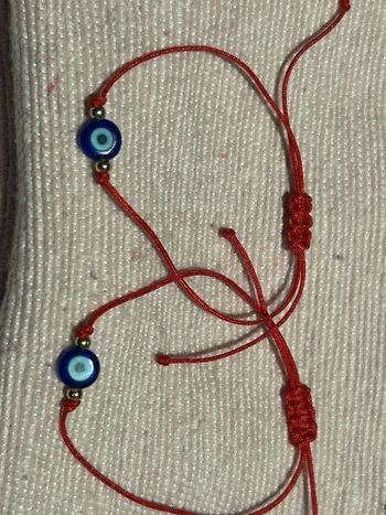 2 bracelets œil cordon rouge acier neufs