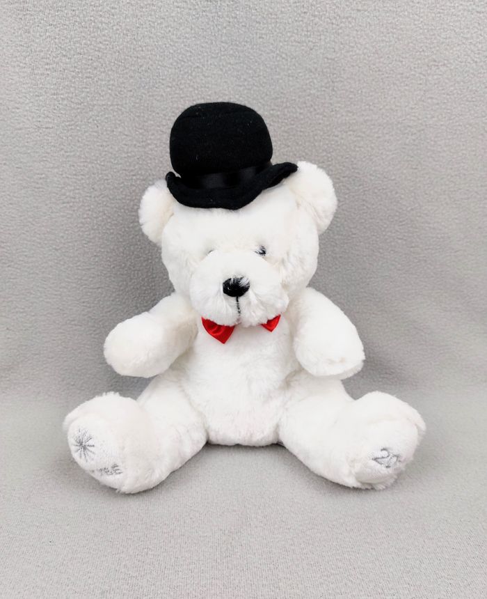 Peluche doudou ours blanc NOCIBE 2012 chapeau noir nœud rouge 28 cm assis étoile