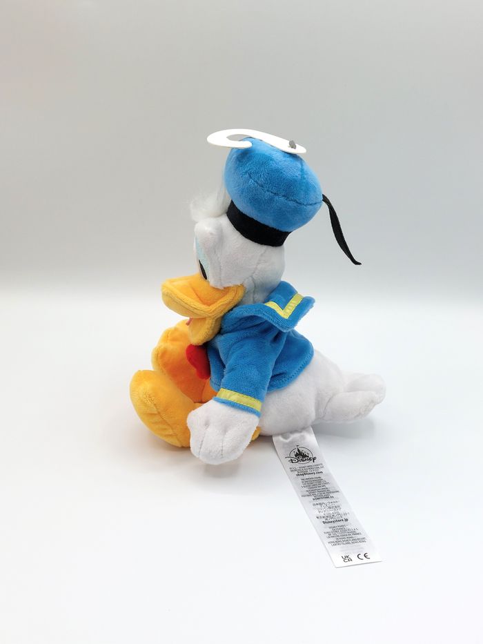 Peluche doudou Donald Duck DISNEYLAND Disneystore noeud rouge 30 cm comme neuf - photo numéro 2