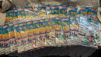25 magazines pokemon + 50 boosters