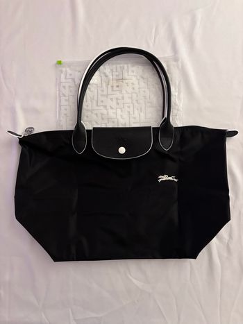Sac Longchamp couleur noir finition blanche