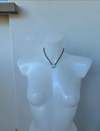 Collier lanière noir avec motif fleur dans un carré argenté