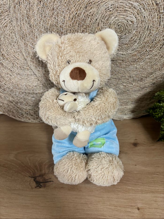 Doudou ours salopette bleu mouton musical tex