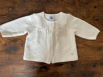 Veste molletonnée beige et dorée avec noeud