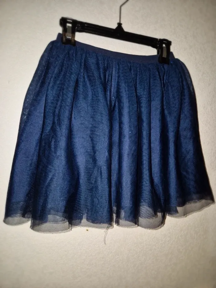 Jupe marine à paillettes effet voile en excellent état, t. 6/8 ans.