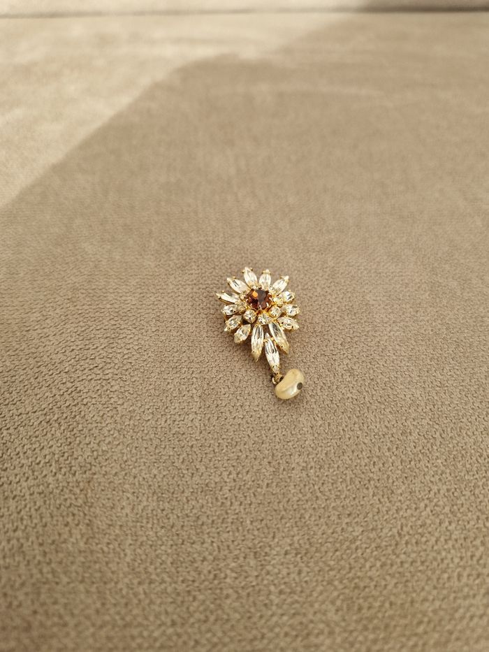 Broche dorée vintage avec ses perles brillantes et sa perle