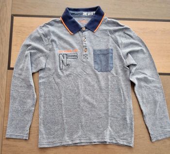 Polo bleu   chiné orchestra 12 ans en très bon état