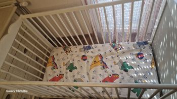 Lit bébé  blanc avec matelas et un meuble blanc 