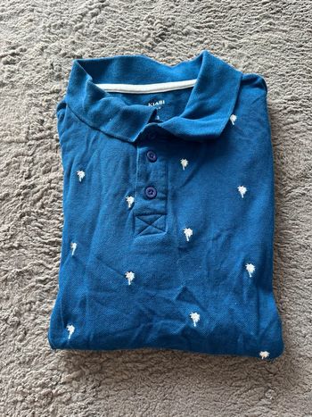 Polo slim fit bleu avec des petits palmiers blancs kiabi taille S