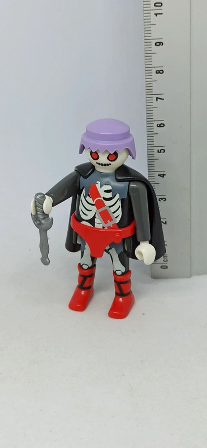 Homme fantôme zombie cheveux violets avec arme et cape noire playmobil