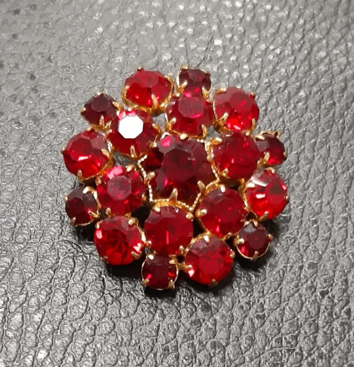 Très belle broche vintage dorée avec cristaux rouges