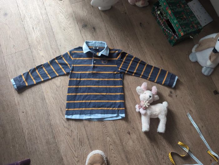 Polo effet superposition et blason lion Cyrillus 10 ans