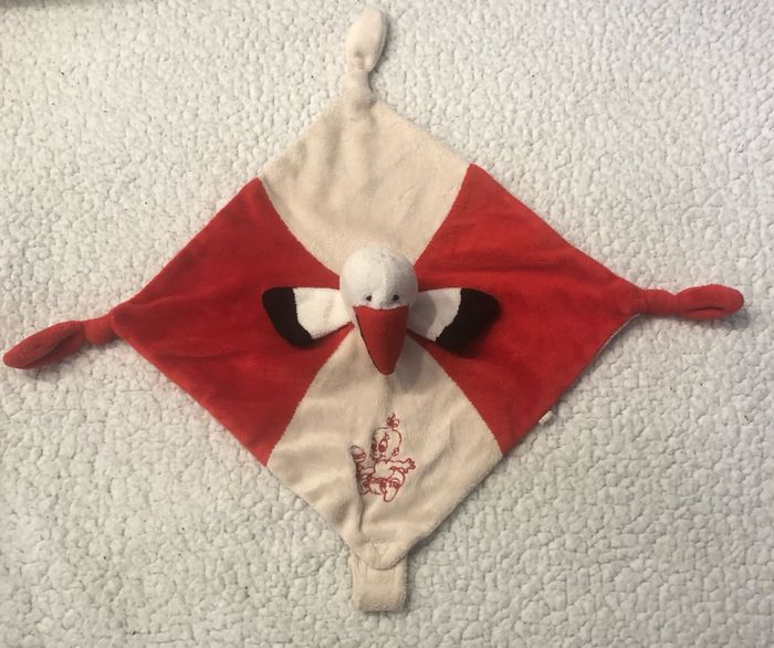 Doudou plat cigogne blanc rouge Roda Rodadou