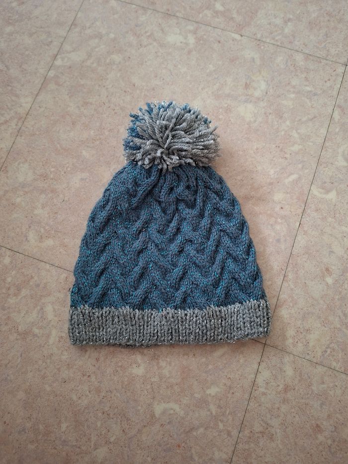Bonnet tricoté bleu et gris à pompon