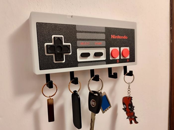 Porte-clés mural rétro NESPorte-clés mural rétro NES Apportez une touche geek et nostalgique à votr