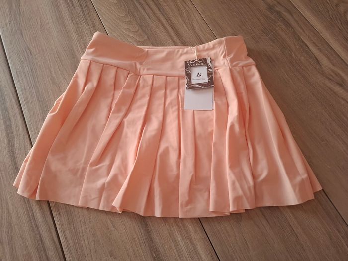Jupe enfant plissée trapèze pour fille avec short intérieur pour le tennis corail