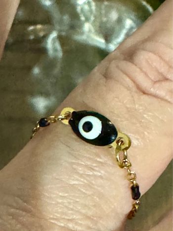 Bague taille 52 acier inoxydable or perles et œil résine noirs