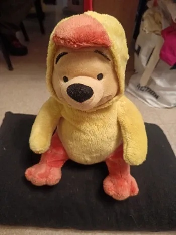 Peluche Winnie l'ourson en coque