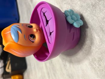 bébé figurine en plastique dans un pot de fleurs