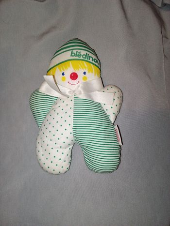 doudou clown  de la marque Corolle de 1994 en tissu 18 cm de haut noeud satin blanc au cou