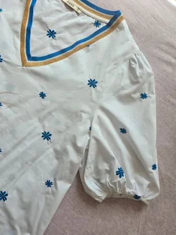 Haut blanc à manches courtes brodé – col V doré et bleu