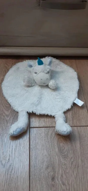 Doudou rond et plat "licorne" blanc/bleu en très bon état