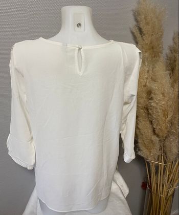 Haut blanc avec manches ouvertes
