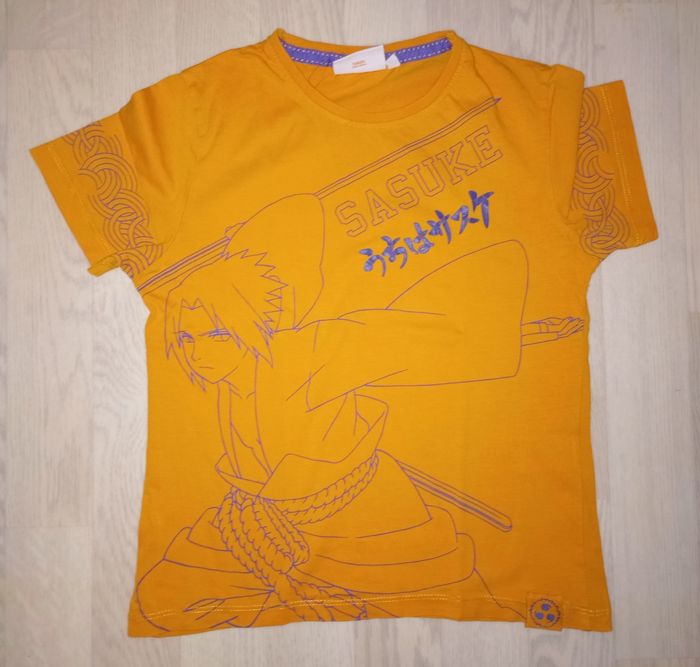 Tee-shirt orange motif Sasuke Naruto 
T. 10 ans