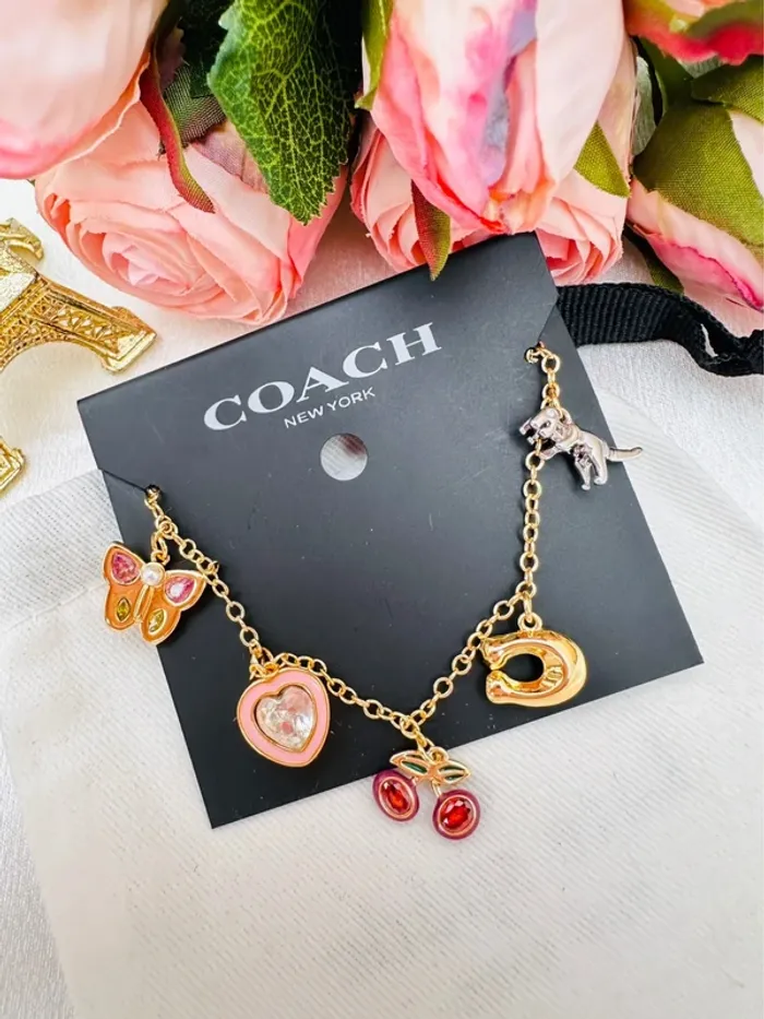 🦖Bracelet charms doré Coach New York – Papillon, cœur, cerises, logo C doré, dinosaure