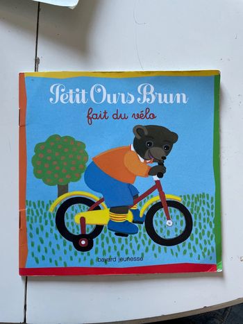 Petit ours brun fait du vélo