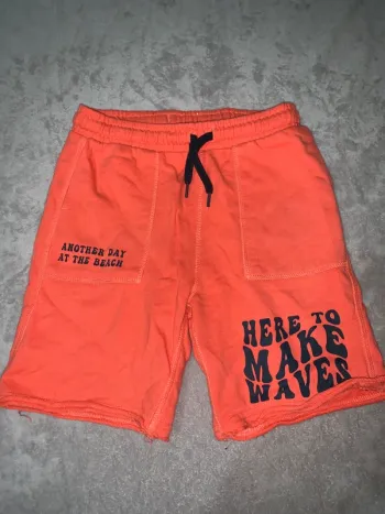 Short orange 'Here to Make Waves'