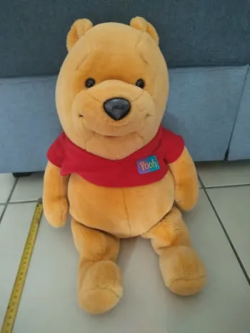 Peluche Range pyjama Winnie l'ourson