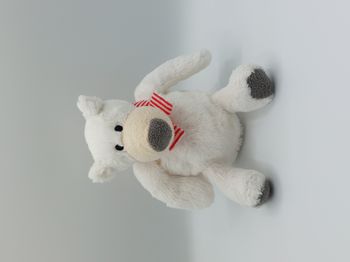 Peluche doudou ours polaire blanc PRIMATIS beige écharpe rayée rouge 20 cm assis