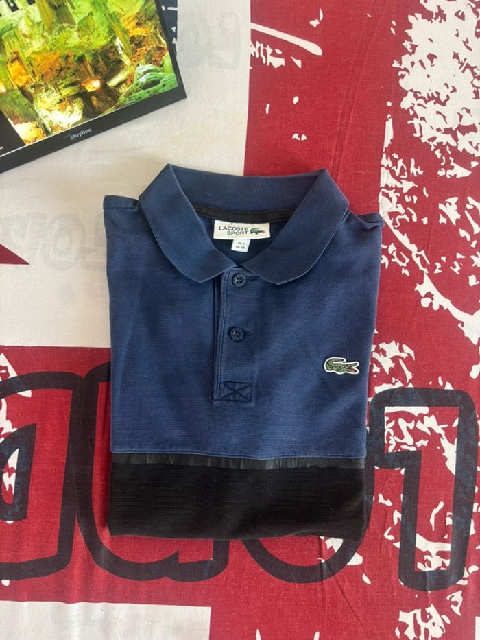 Polo Lacoste taille xs bleu et noir